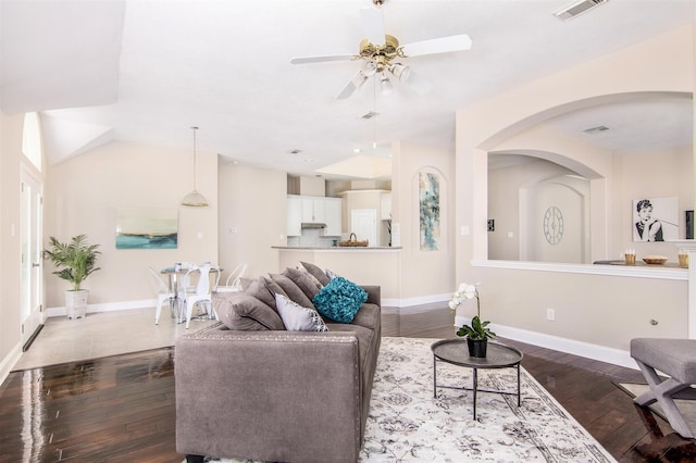 living room with lofted ceiling, dark wood-type flooring, and ceiling fan