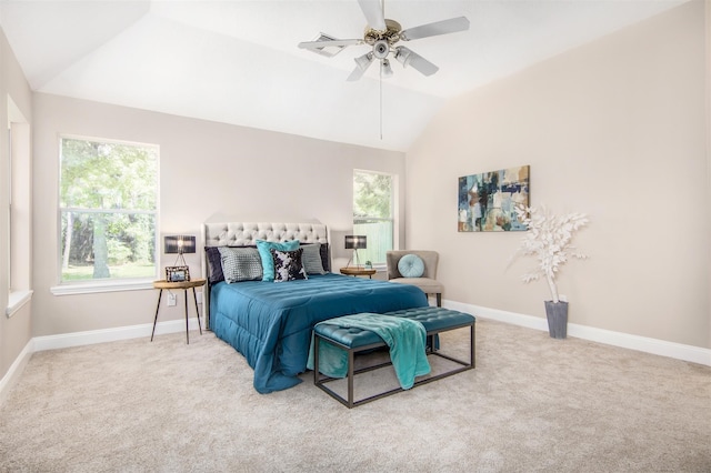 carpeted bedroom with lofted ceiling, ceiling fan, and multiple windows