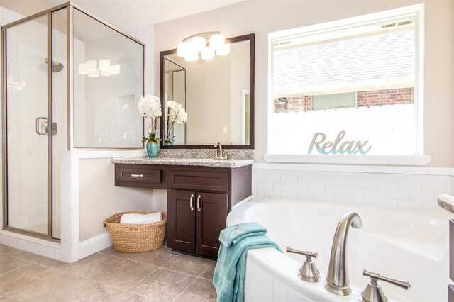 bathroom featuring vanity, a healthy amount of sunlight, and independent shower and bath