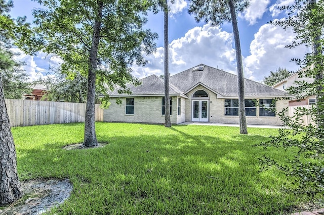 rear view of house featuring a yard