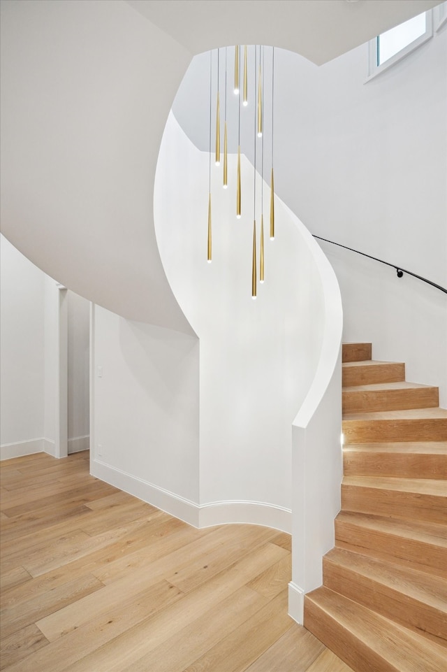 stairs featuring hardwood / wood-style floors