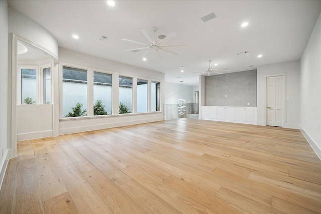 unfurnished living room with ceiling fan and light wood-type flooring