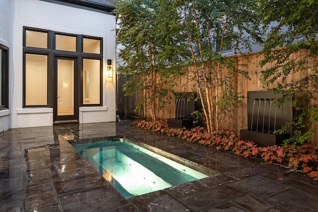 view of swimming pool featuring an in ground hot tub and a patio area