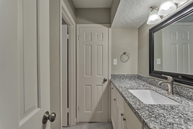 bathroom featuring vanity and a textured ceiling