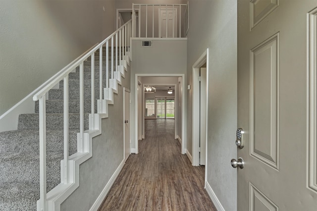 foyer featuring hardwood / wood-style floors and a high ceiling