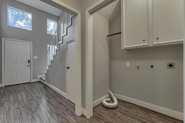 laundry room featuring electric dryer hookup, cabinets, dark wood-type flooring, and hookup for a gas dryer