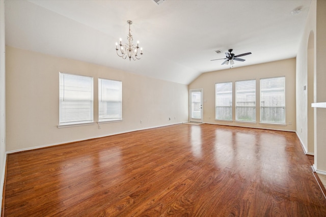 unfurnished living room featuring lofted ceiling, dark wood-type flooring, and ceiling fan with notable chandelier