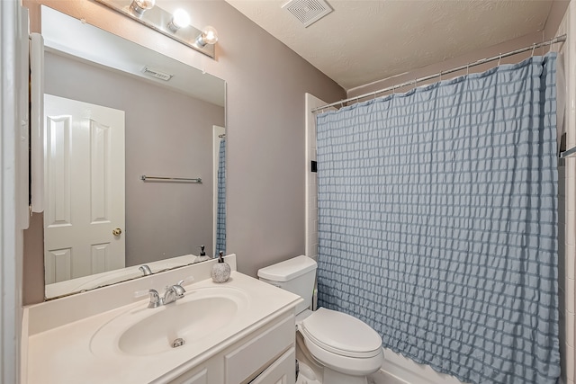 bathroom with vanity, a shower with shower curtain, a textured ceiling, and toilet