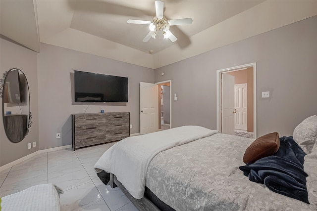 bedroom featuring ceiling fan and a tray ceiling