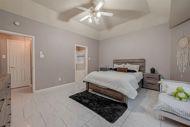 bedroom with ensuite bath and ceiling fan