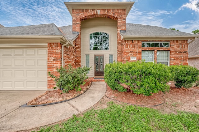 doorway to property with a garage