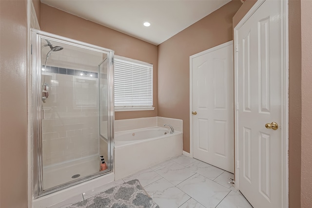 bathroom featuring shower with separate bathtub