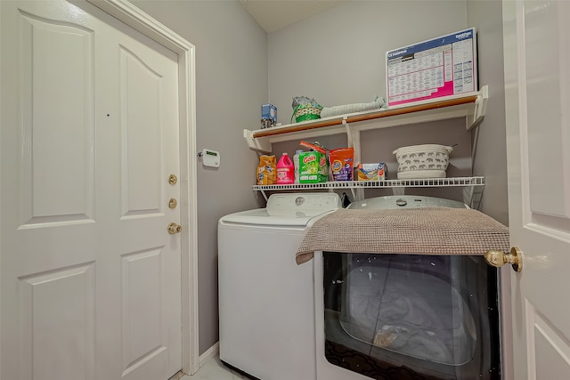 clothes washing area featuring washing machine and clothes dryer