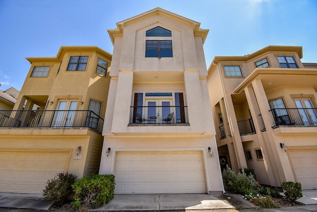 multi unit property with a garage and a balcony