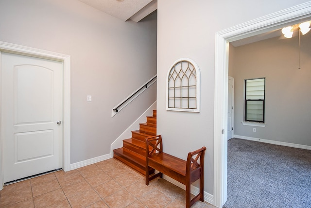 stairs featuring a textured ceiling and tile patterned floors