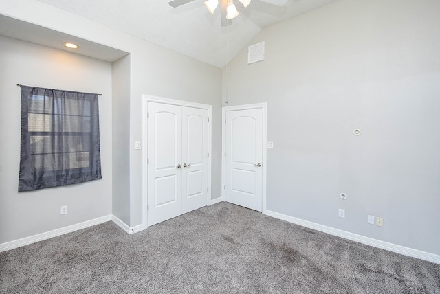 unfurnished bedroom featuring vaulted ceiling, a closet, ceiling fan, and carpet flooring