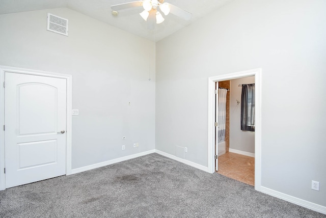 spare room with lofted ceiling, ceiling fan, and carpet