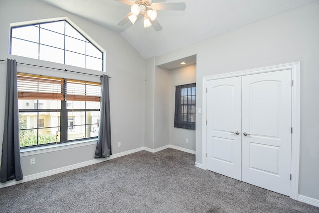 unfurnished bedroom featuring ceiling fan, a closet, carpet floors, and vaulted ceiling