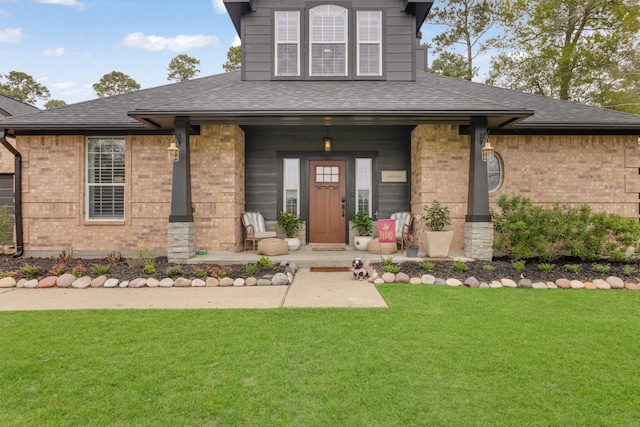 view of front of property with a front yard and a porch