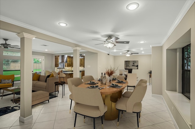 tiled dining room with ceiling fan, crown molding, and decorative columns