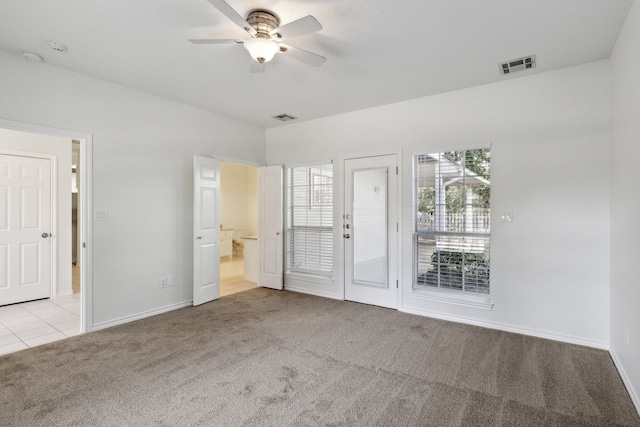 spare room featuring ceiling fan and light carpet