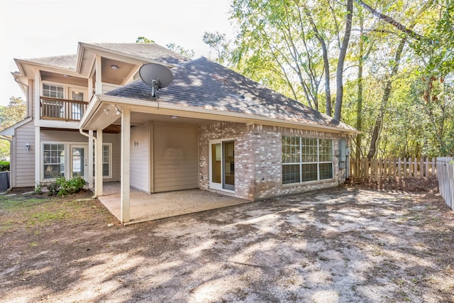 back of house featuring a balcony and a patio area