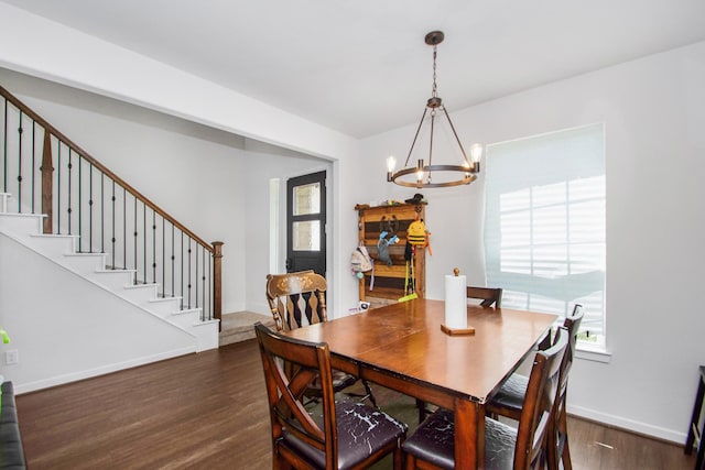 dining room featuring dark wood-type flooring and a chandelier