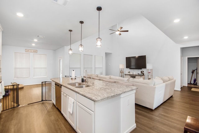 kitchen with ceiling fan, sink, light stone counters, stainless steel dishwasher, and white cabinets