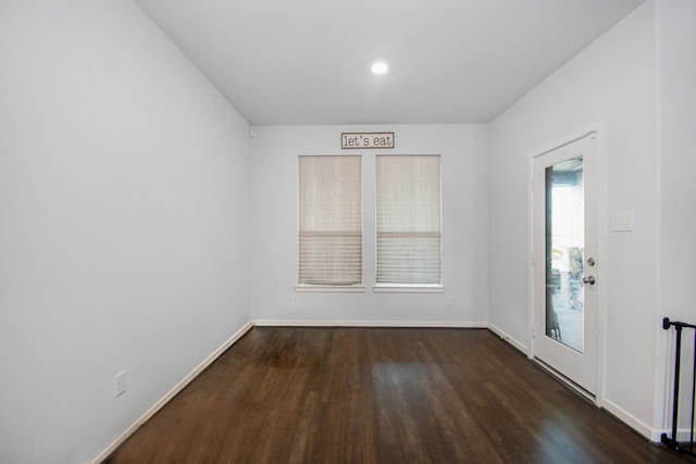 spare room featuring dark wood-type flooring