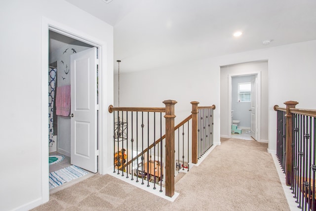 hallway with light colored carpet