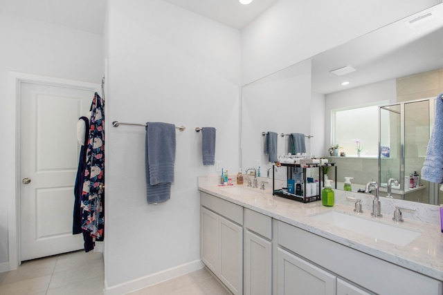 bathroom featuring tile patterned floors, vanity, and a shower with shower door