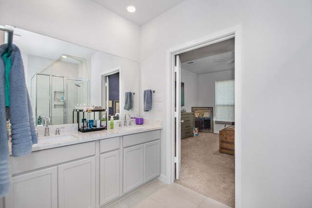 bathroom featuring vanity, tile patterned floors, and walk in shower