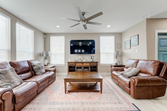 living room featuring ceiling fan and light wood-type flooring