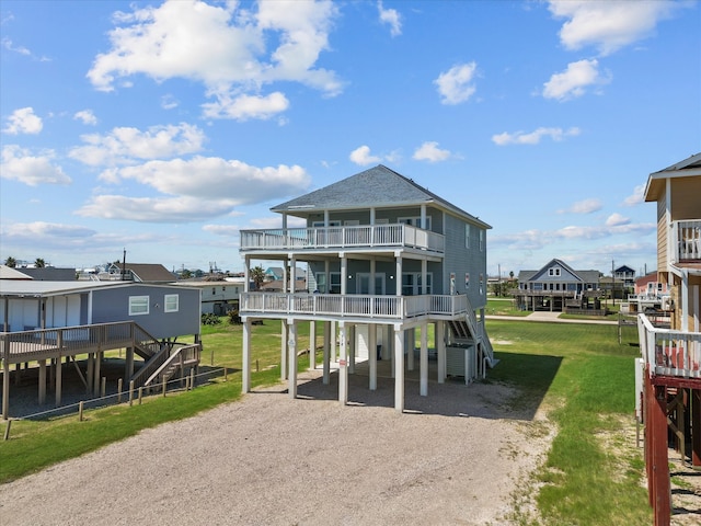 rear view of property with a balcony and a carport