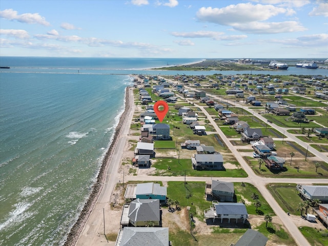 birds eye view of property featuring a beach view and a water view