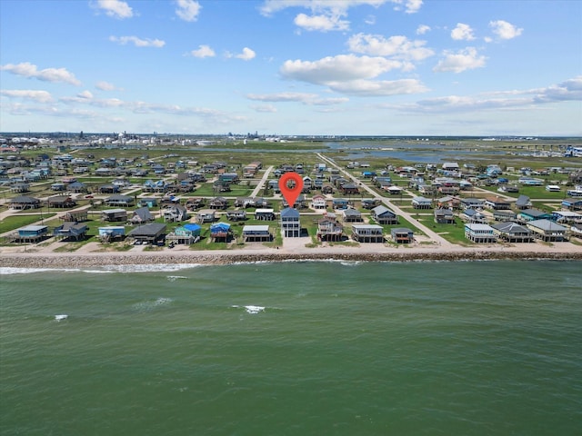 birds eye view of property with a water view, a beach view, and a residential view