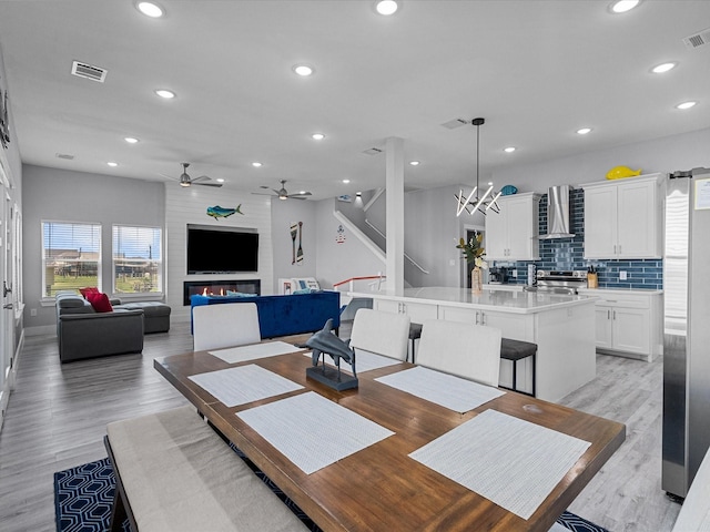 dining area with visible vents, ceiling fan with notable chandelier, and recessed lighting