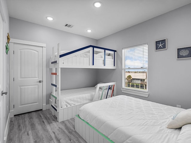 bedroom featuring recessed lighting, baseboards, visible vents, and wood finished floors