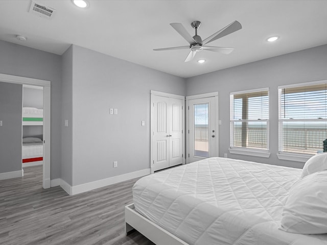 bedroom with wood finished floors, a ceiling fan, visible vents, baseboards, and recessed lighting
