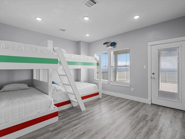 bedroom featuring baseboards, recessed lighting, visible vents, and wood finished floors