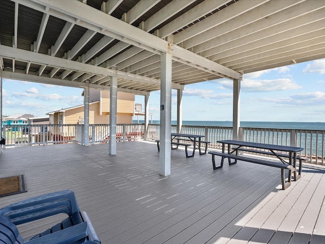 wooden terrace featuring a water view