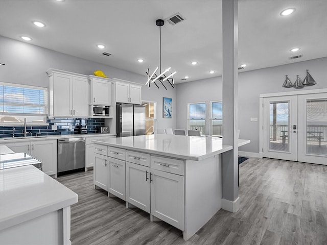 kitchen featuring recessed lighting, a wealth of natural light, stainless steel appliances, and a sink