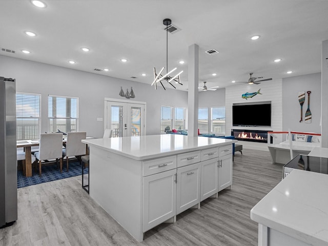 kitchen featuring recessed lighting, ceiling fan with notable chandelier, visible vents, and light wood-style floors