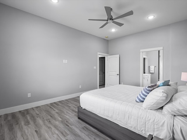 bedroom with wood finished floors, recessed lighting, ceiling fan, connected bathroom, and baseboards