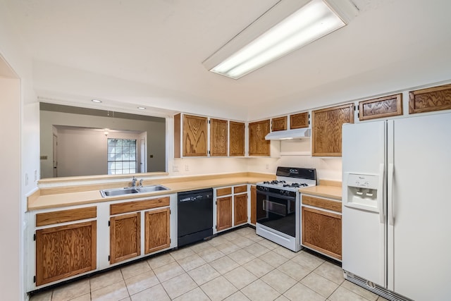 kitchen with sink, white appliances, and light tile patterned flooring