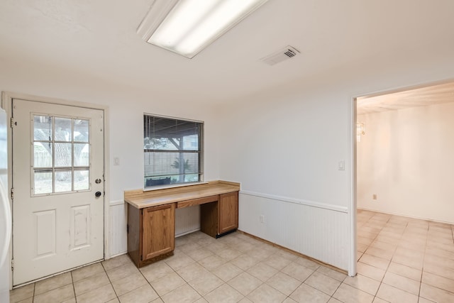 unfurnished office with light tile patterned flooring