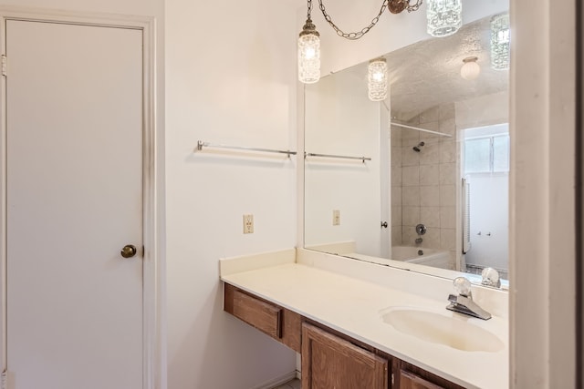 bathroom with vanity and tiled shower / bath combo