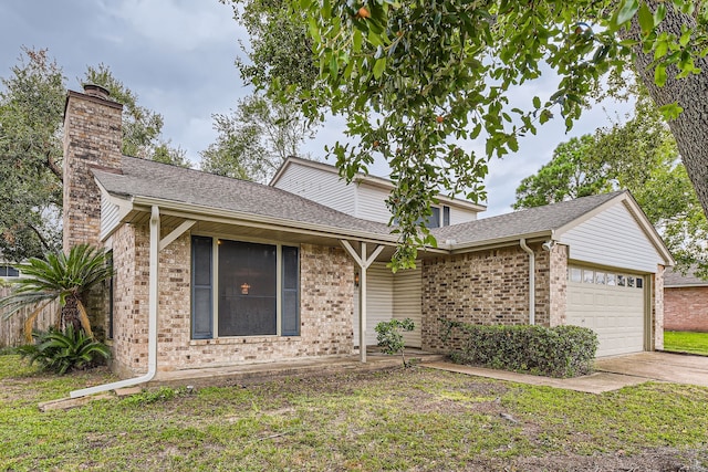 view of front of home featuring a garage and a front yard