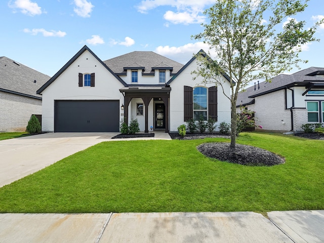 view of front of home with a garage and a front lawn