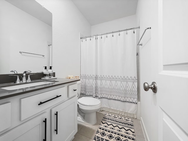 bathroom featuring vanity, toilet, a shower with curtain, and tile patterned floors